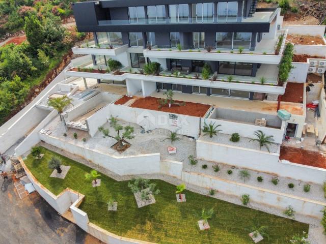 OPATIJA, CENTER - larger apartment in an exclusive new building above the center of Opatija with pri