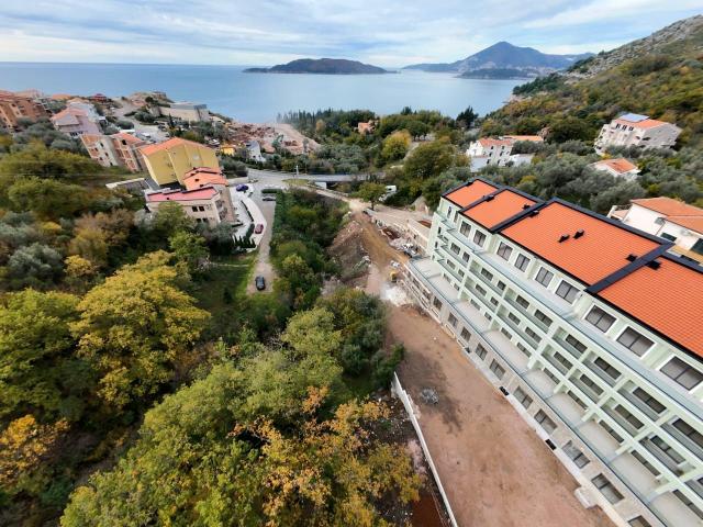 Prodaja jednosobnog stana 57m² u novogradnji sa bocnim pogledom na more, parkingom i oslobođenjem od